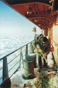 This is a photo of a scientist with plankton gear standing on the icebreaker deck.