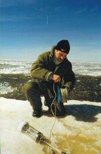 This is a photo of a scientist who is doing phytoplankton sampling through the ice